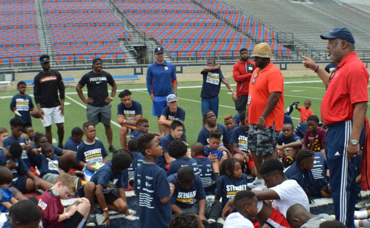 Caddo Parish District Attorney James E. Stewart Sr. encourages participants at the fourth annual free Caddo DA Youth Football Camp at Independence Stadium Saturday, May 18, 2019. Listening in back, from left, are Cincinnati Bengals safety Brandon Wilson, San Francisco '49ers cornerback Ramon Broadway, former Cleveland Browns quarterback Josh Booty and New York Giants cornerback Michael Hunter.
