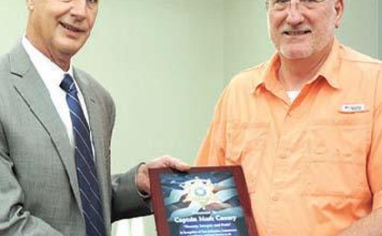 Bossier Sheriff Julian Whittington conducted a retirement ceremony for Capt. Mark Causey (left) and Deputy Paul Hopkins (right).