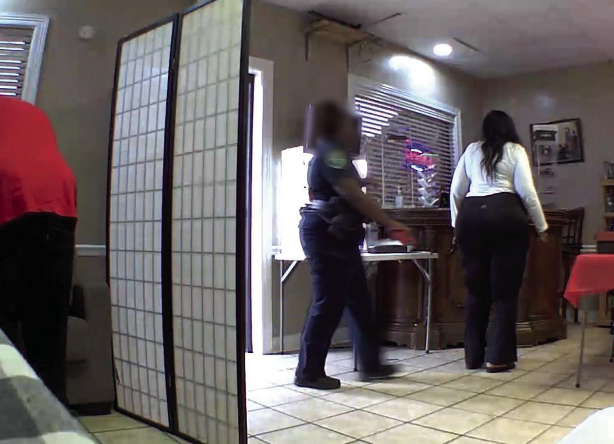 Surveillance footage shows an SPD officer returning items to a business, Aug. 26. (Courtesy: KSLA News 12)