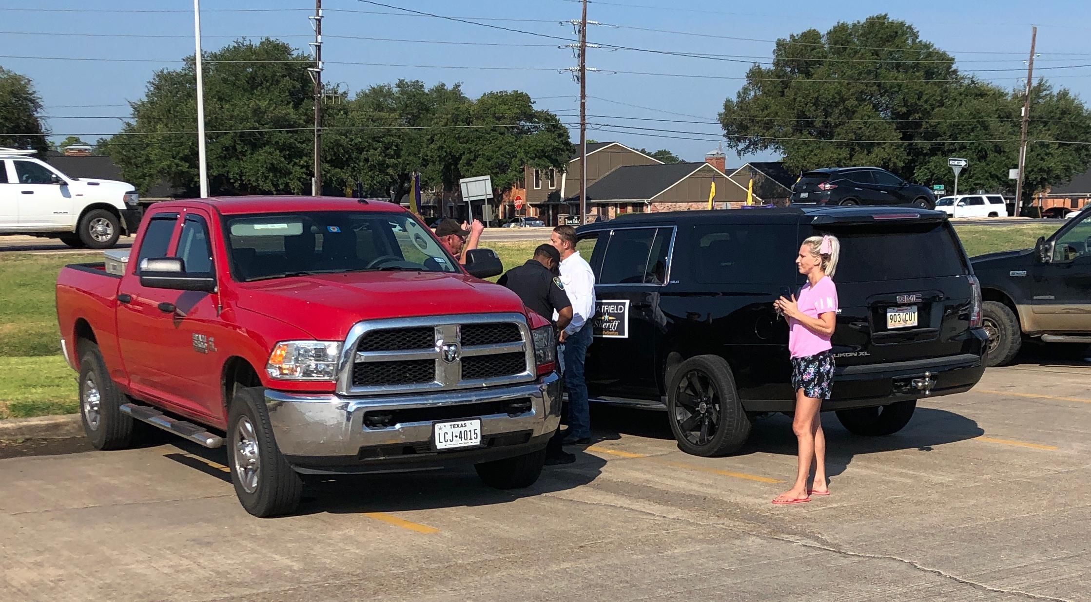 Eric Hatfield calls police, irate over man holding "LyingEric.Com" sign.