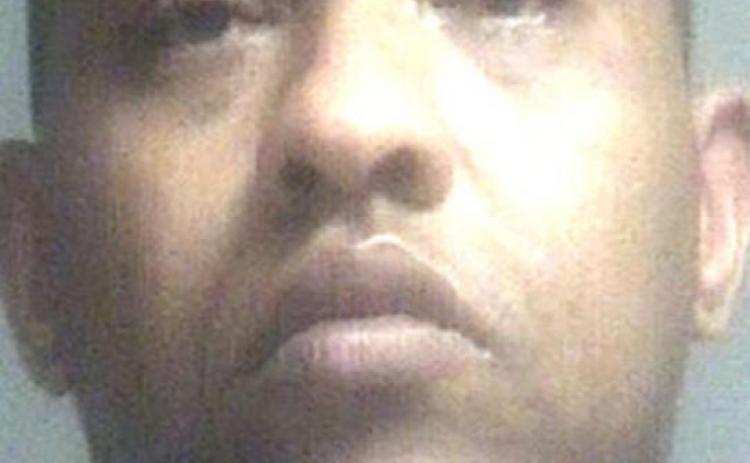Man refuses to let two people leave Bossier motel room