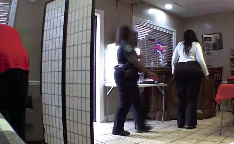 Surveillance footage shows an SPD officer returning items to a business, Aug. 26. (Courtesy: KSLA News 12)
