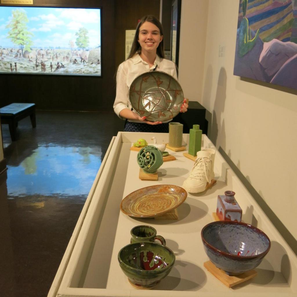Potter Autumn Tipton with some of her work.