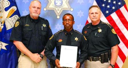 Deputy Jon-Marco Daughtery with Sheriff Jay Long and Chief John May. Caddo Sheriff awards deputies for heroism, lifesaving acts!