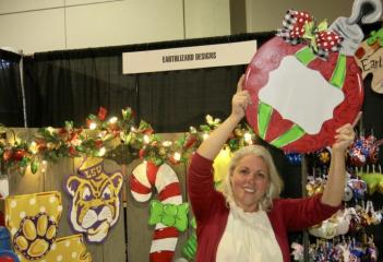 LEFT: Vendor Liz Elley at Earthlizard Designs booth showing her hand-painted sign creations. Les Boutiques De Noel hits a home run