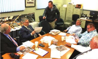 Ryan Estes (center, standing) makes a point during Wednesday’s Bossier Paris Police Jury Road/Subdivision Regulations Committee meeting. Listening are (from left) police jury members Bob Brotherton and Glenn Benton, Parish Engineer Butch Ford and jury m Article Image Alt Text