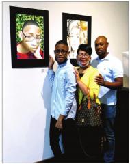Michael Landry, with his parents, Lakeha and Charles Payton, shows his mixed media self-portrait, “Me, Myself, and I.” AN ARTY AFFAIR