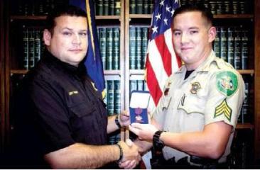 DeSoto Parish Sheriff Jason Richardson (left) recognizes Sgt. Dakota Gingles for his efforts in saving the life of a gunshot victim in March by stopping the victim’s bleeding. Article Image Alt Text
