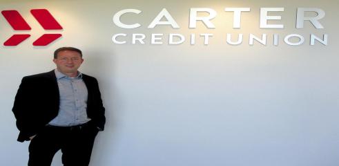 Joe Arnold helps citizens with their finances at Carter Credit Union