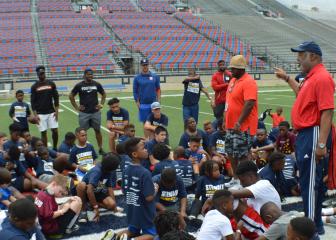 Caddo Parish District Attorney James E. Stewart Sr. encourages participants at the fourth annual free Caddo DA Youth Football Camp at Independence Stadium Saturday, May 18, 2019. Listening in back, from left, are Cincinnati Bengals safety Brandon Wilson, San Francisco '49ers cornerback Ramon Broadway, former Cleveland Browns quarterback Josh Booty and New York Giants cornerback Michael Hunter.